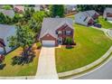 Aerial view of a brick two-story home showcasing its landscaped yard and neighborhood at 2990 Haynes Club Cir, Grayson, GA 30017
