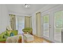 Cozy living room with comfortable seating, natural light, and private backyard entrance at 4025 Cheoah Dr, Douglasville, GA 30135
