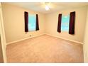Inviting bedroom with plush carpeting, two windows, and neutral wall paint at 5167 Hiram Lithia Springs Rd, Powder Springs, GA 30127