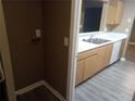 Spacious kitchen featuring a pass-through, white countertops and stainless steel sink at 8202 Fairington Village Dr, Lithonia, GA 30038