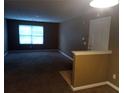 Inviting living room with a large window for natural light and neutral carpeting at 8202 Fairington Village Dr, Lithonia, GA 30038