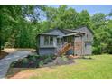 Charming two-story home featuring gray siding, wood porch and a beautifully landscaped yard at 3427 Mill Stream Sw Ln, Marietta, GA 30060