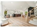 Open living space featuring modern kitchen, dining area, and stone fireplace at 3427 Mill Stream Sw Ln, Marietta, GA 30060