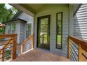 Covered porch featuring wood floors, metal railing, and a view of the front yard at 3427 Mill Stream Sw Ln, Marietta, GA 30060