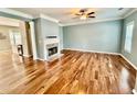 Bright living room with hardwood floors, fireplace and an open-concept design at 3988 Church View Ln, Suwanee, GA 30024