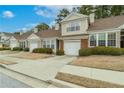 Attractive townhome exterior with lush landscaping, attached garage, and inviting facade at 124 Camry Ln, Grayson, GA 30017