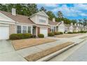 A row of well-maintained townhomes with mature landscaping and attached garages at 124 Camry Ln, Grayson, GA 30017