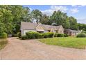 Charming stone home featuring a well-maintained lawn and mature landscaping at 5128 Lavista Rd, Tucker, GA 30084