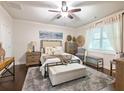 Comfortable bedroom featuring a ceiling fan, neutral decor, hardwood floors, and a large window at 2506 Skyland Ne Dr # 17, Atlanta, GA 30319