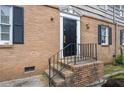 Close-up of the front door entrance with brick steps and classic black door at 3626 Buford Ne Hwy # C1, Brookhaven, GA 30329