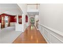 Grand foyer with hardwood floors leading to living spaces featuring elegant archways, and staircase at 5909 Rue Chase Way, Tucker, GA 30084