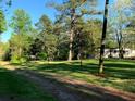 Exterior shot of the home surrounded by trees and greenery at 6675 Millwood Rd, Cumming, GA 30041