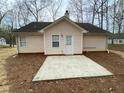 Home's backyard featuring a concrete patio perfect for outdoor entertaining and relaxation at 233 Winterville Dr, Rockmart, GA 30153