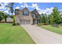 Charming home featuring an attached two-car garage, well-manicured lawn and mature landscaping at 3483 Addilyn Ne Ct, Marietta, GA 30066