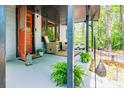 Cozy front porch featuring outdoor seating, plants, and a decorative hanging lantern at 391 Buchanan St, Dallas, GA 30157