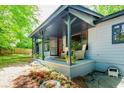 Inviting front porch with seating, plants, and flower garden, perfect for relaxing outdoors at 391 Buchanan St, Dallas, GA 30157