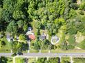 Wide aerial shot displays sprawling greenery, a home, and a road with vehicle traffic at 14301 Veterans Memorial Highway, Villa Rica, GA 30180
