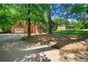 Shot shows a brick home from the driveway, with a lush yard and an additional building visible at 14301 Veterans Memorial Highway, Villa Rica, GA 30180