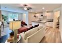 Bright and airy living area with hardwood floors, a fireplace, and an open layout to the kitchen at 1824 Emory Ln # 88, Conyers, GA 30013