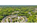 Aerial view of a neighborhood showcasing lush greenery, well-spaced homes, and mature trees at 2185 Creole Cir, Cumming, GA 30040
