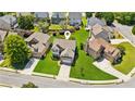 An aerial shot of a well-maintained property featuring green lawns and mature landscaping in a suburban neighborhood at 2185 Creole Cir, Cumming, GA 30040