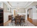Elegant dining room features a chandelier, wainscoting, and seating for six at 2185 Creole Cir, Cumming, GA 30040