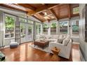 Bright sun room with hardwood floors, wood ceiling and beams, and lots of windows at 3999 Brintons Ml, Marietta, GA 30062