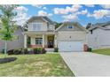 Charming two-story home features a covered front porch and attached two car garage at 7760 Hansel Ln, Lithonia, GA 30058