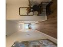 Hallway with wood flooring, neutral walls, and decorative mirror and console table at 4265 Sw Notting Hill Sw Dr, Atlanta, GA 30331