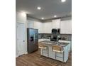 Modern kitchen featuring white cabinets, granite countertops, stainless steel appliances and a central island at 4265 Sw Notting Hill Sw Dr, Atlanta, GA 30331