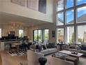 Open concept living and kitchen area with high ceilings and large windows creating a light-filled and airy space at 750 Keystone Dr, Woodstock, GA 30188