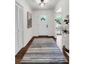 Inviting foyer with modern rug and light fixture and view to formal spaces at 3420 Burnt Hickory Nw Rd, Marietta, GA 30064