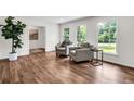 Bright living room with hardwood floors, neutral paint, and large windows at 3420 Burnt Hickory Nw Rd, Marietta, GA 30064