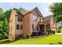 Charming two-story brick and siding home with manicured landscaping and inviting curb appeal at 6175 Beaver Crossing Dr, Cumming, GA 30040
