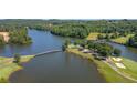 Scenic aerial view of a lakefront community with a golf course and bridges connecting the landscape at 1028 Southwood Dr, Villa Rica, GA 30180
