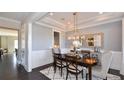 Dining room with hardwood floors, wainscoting, a stylish light fixture, and seating for six at 2905 Medford Drive, Cumming, GA 30041