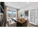 Bright home office with a large window, stylish desk, and elegant French doors at 2905 Medford Drive, Cumming, GA 30041