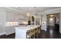 Modern kitchen with stainless steel appliances, a large center island, and pendant lighting at 2905 Medford Drive, Cumming, GA 30041