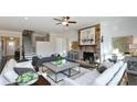Cozy living room with a stone fireplace, hardwood floors, neutral decor, and an inviting atmosphere at 2905 Medford Drive, Cumming, GA 30041