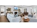 Inviting living room with a cozy fireplace, plush seating, and stylish decor at 2905 Medford Drive, Cumming, GA 30041