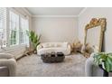 Elegant living room showcasing a decorative mirror, plush seating, and ample natural light at 3998 Commodore Dr, Atlanta, GA 30341