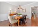 Bright dining room features hardwood floors, wainscoting, and a stylish chandelier at 1313 Cobblestone Ln, Woodstock, GA 30189