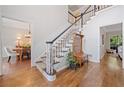 Elegant foyer with hardwood floors and a staircase featuring a decorative stair runner at 1313 Cobblestone Ln, Woodstock, GA 30189