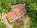 Aerial view of a charming home with a brick roof, mature trees, and a private driveway at 1482 N Decatur Ne Rd, Atlanta, GA 30306