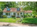 Inviting home with brick details, a well-manicured lawn, and lush landscaping at 1482 N Decatur Ne Rd, Atlanta, GA 30306