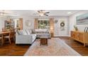 Bright and airy living room with a large sectional sofa, hardwood floors, and natural light at 5725 Brenda Sw Dr, Mableton, GA 30126