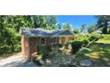 Brick home with a well-manicured yard and mature trees, offering a serene setting at 2663 Washington Nw St, Atlanta, GA 30318