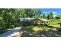 Lovely brick ranch-style home with mature trees and fresh green lawn at 2663 Washington Nw St, Atlanta, GA 30318
