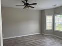 Bright bedroom with new floors, a ceiling fan, and natural light from multiple windows at 4805 Madison Point Cir, Austell, GA 30106