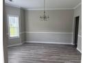 Dining room with new floors, large window, and elegant chandelier at 4805 Madison Point Cir, Austell, GA 30106